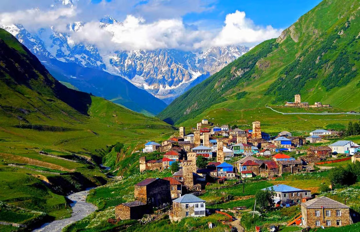 colorful village in Svaneti region of Georgia on green mountain background