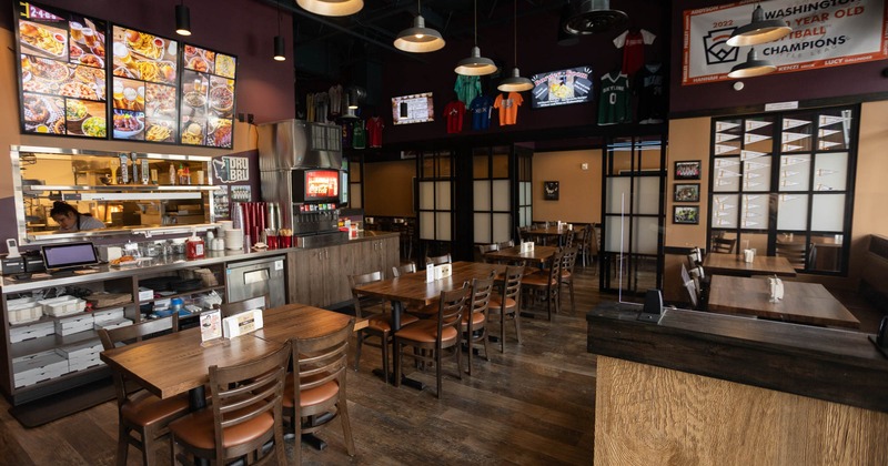 Interior, tables for four and six, prep station, soda fountain, checkout counter