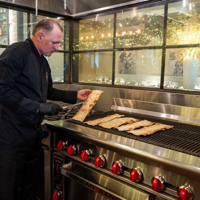 Chef grilling bread.