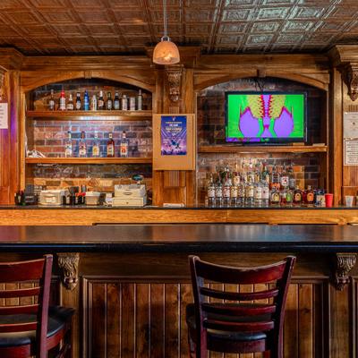 Interior, bar chairs, counter and back bar.
