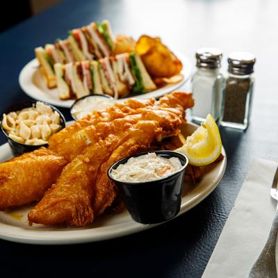 Beer battered fried cod with coleslaw, macaroni salad and potatoes.