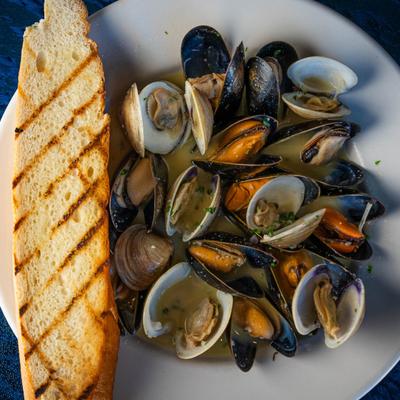 Mussels and clams in white wine, sauce, served with French bread.