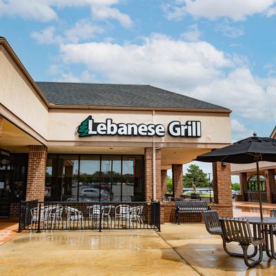 Lebanese Grill exterior with signage and outdoor seating.