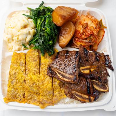 Grilled meat, kimchi, spinach, potato wedges, egg strips, and creamy potato salad.