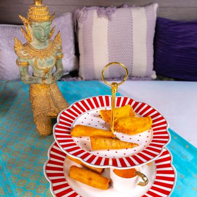 The Palace Sampler served on a two-tier red-and-white striped serving stand.