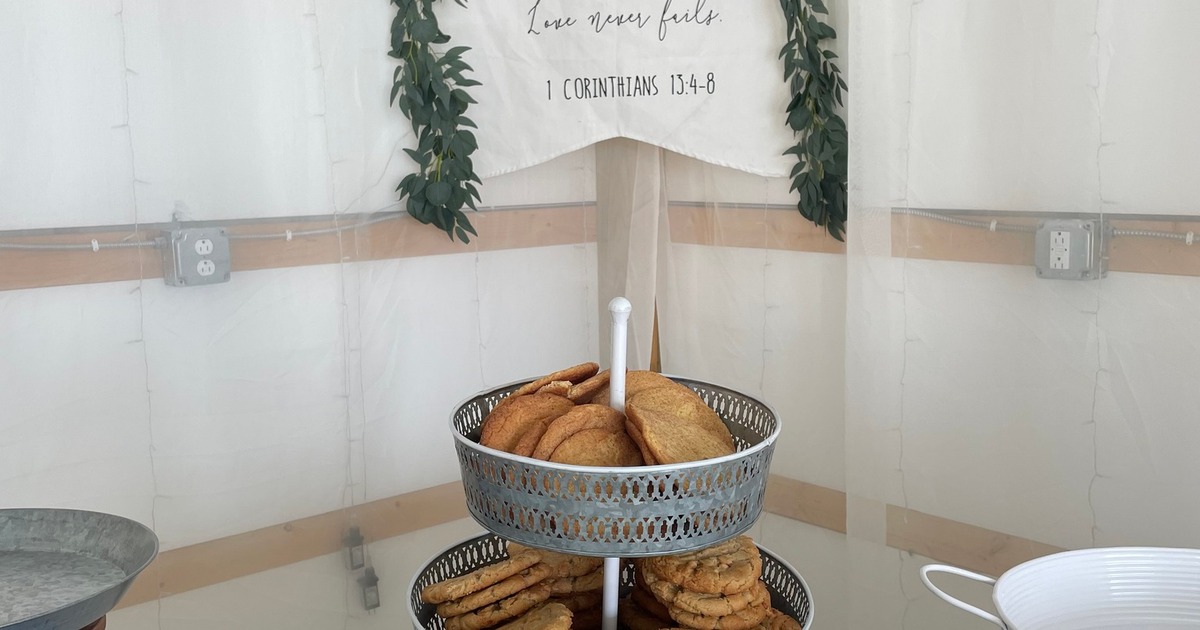 Tiered dessert stand with cookies and handwritten signs