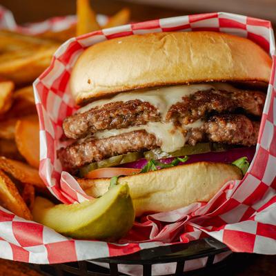 Classic burger with fries and a pickle.