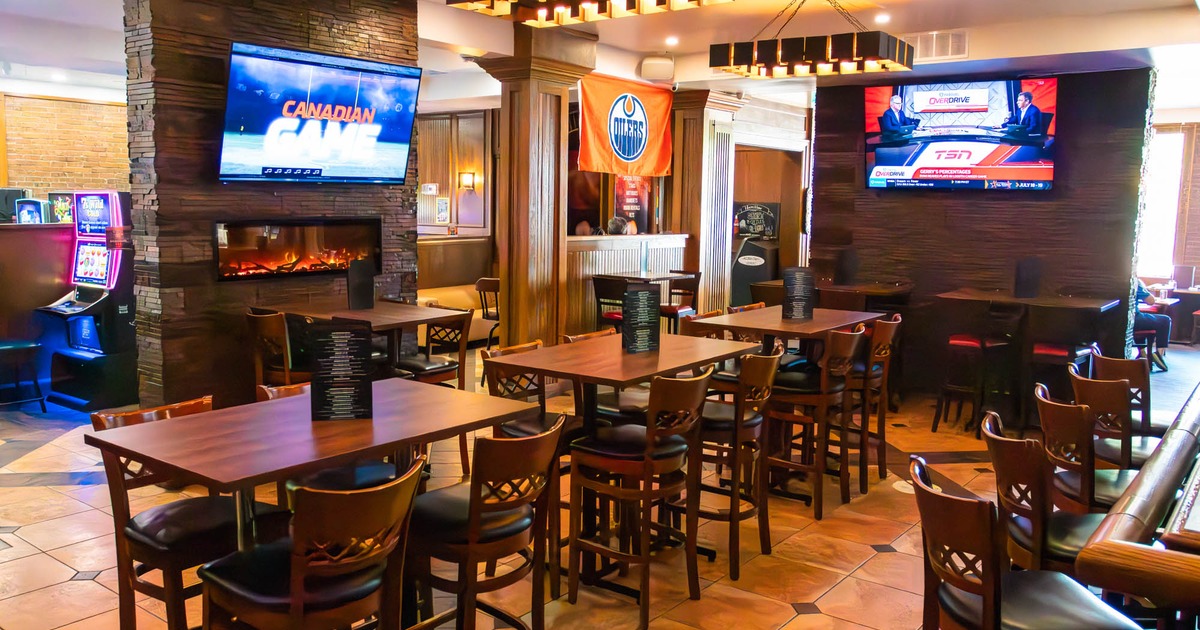 Interior, wooden tables and chairs, wall-mounted televisions