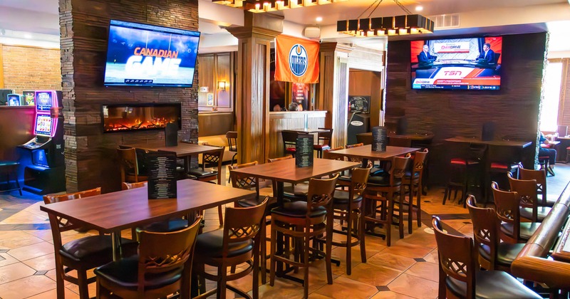 Interior, wooden tables and chairs, wall-mounted televisions