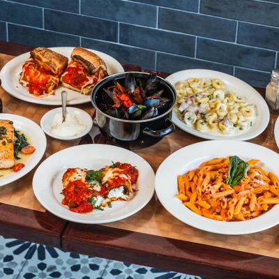 Assorted Italian dishes displayed on a wooden table.