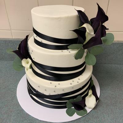 A three tiered black and white cake wedding cakes