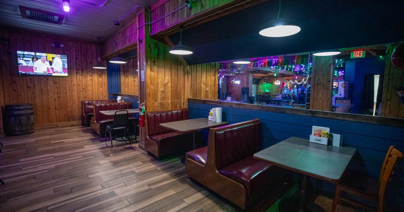 Interior, dining area, seating booths with tables and chairs, wood coated walls