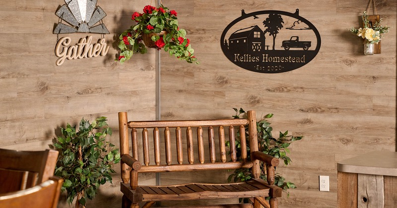 Restaurant interior with a wooden bench, potted plants and wall decororation