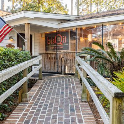 Restaurant entrance with brick walkway.