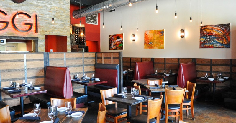Dining area with set tables and booths, paintings on a wall