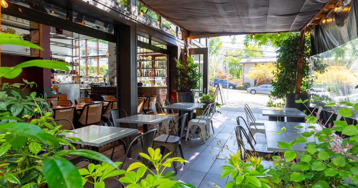 Exterior seating area with metal chairs and tables