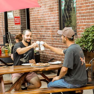 People making a toast with their drinks.
