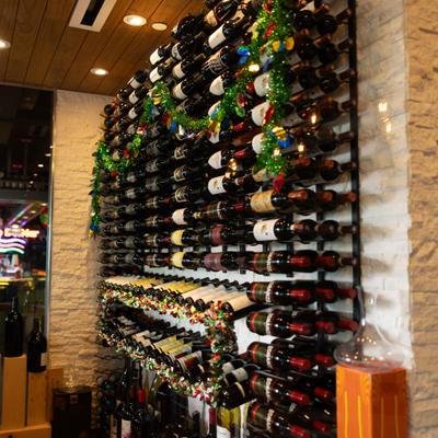 Wall display of stacked wine bottles.