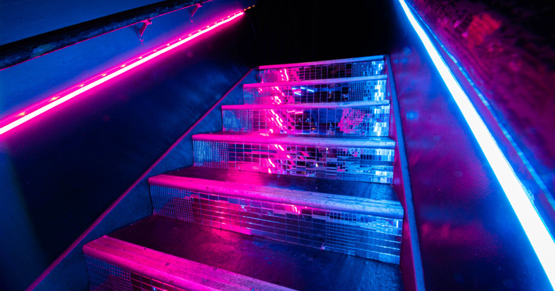 Interior, neon lit staircase