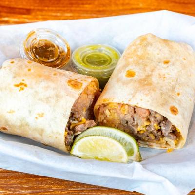 Steak burrito, filled with rice, beans, and pico de gallo.