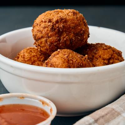 Southern Cheese Balls served with a dipping sauce.