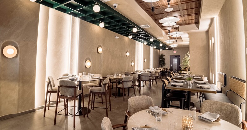 Interior, dining area, tables for four, banquette benches with tables and chairs