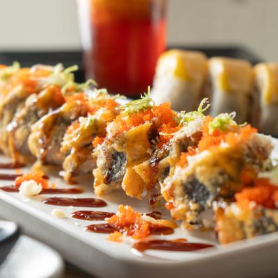 Spring Hill Roll topped with eel sauce and, tempura crunch and green onion.