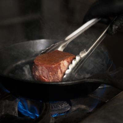 Filet Mignon searing on a pan.
