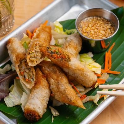Laos Egg Rolls stuffed with chicken, served with sweet and sour sauce.