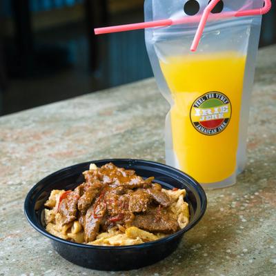 Pepper steak and a packed drink.
