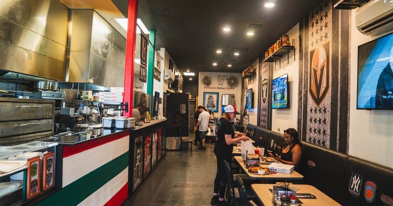 Food counter line and tables and chairs by the wall