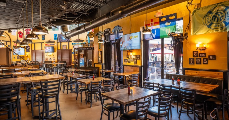 Interior, tables and chairs, TV screen on the wall