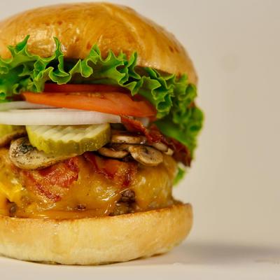 A fully assembled cheeseburger on a brioche bun.