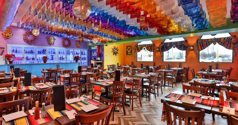 Interior, decorated room, dining tables set and ready for guests