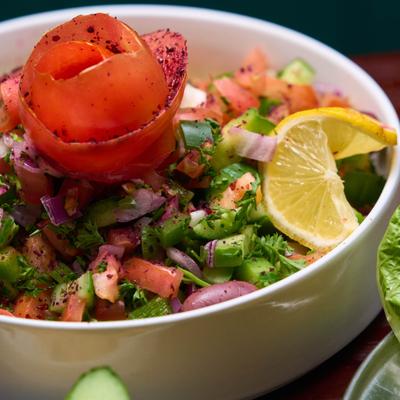 Shepherd Salad with tomatoes, cucumber, green peppers, onions and parsley.