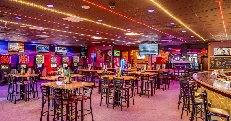 View of a dining area, darts on the right, tables in the middle