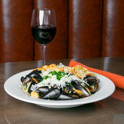 Steamed mussels topped with Parmesan, parsley, and sexy bread, served with red wine.