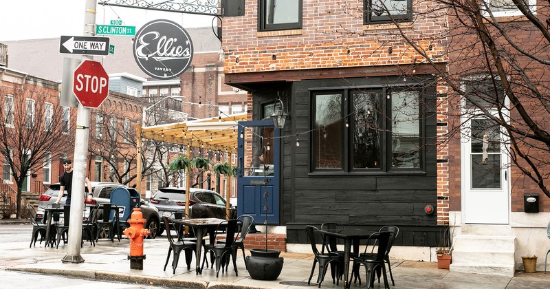 Exterior space, tables and chairs in front of the entrance