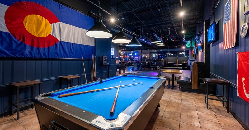 Pool table, bar area in the background