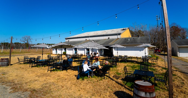 Exterior, restaurant, patio in front, tables, chairs, parasols