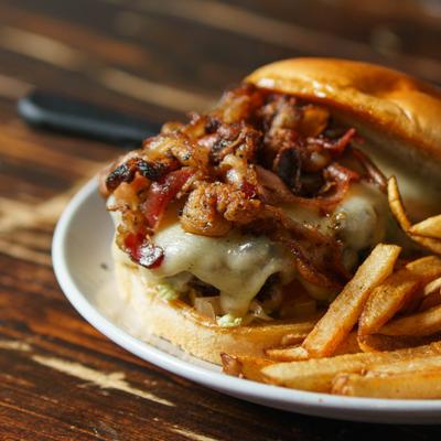Bacon Swiss burger served with fries.