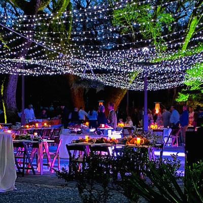Outdoor patio covered in lights at night.