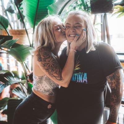 A kiss on the cheek between two guests