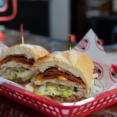 Sandwich with turkey, bacon, cheddar cheese, and lettuce.