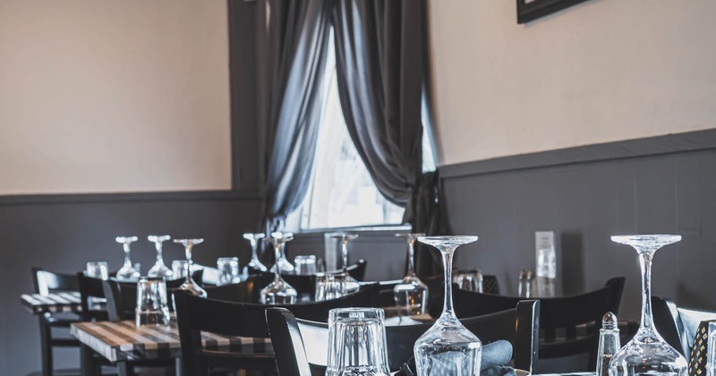 Interior, diner tables set,  next to the window