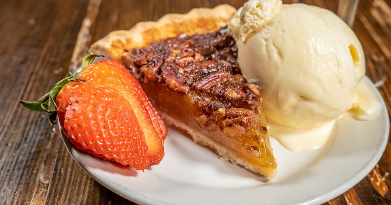 Pecan Pie, with a scoop of vanilla ice cream and strawberries