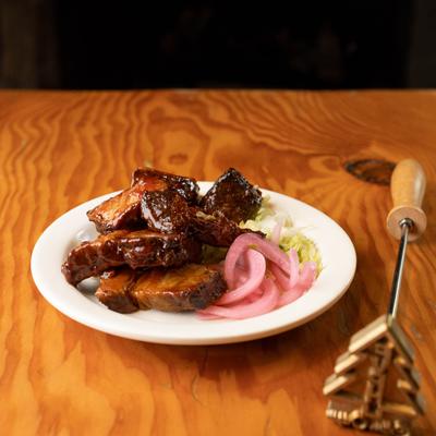 Burnt ends, with sweet and salty seasoning, BBQ sauce, and salad.