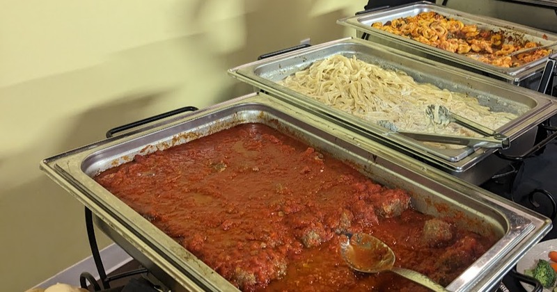 Trays with meatballs, fettuccine Alfredo, and Tortellini pasta dish