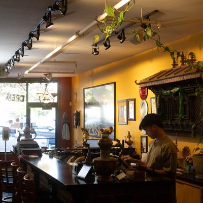 Interior, cash register with a staffer in action.