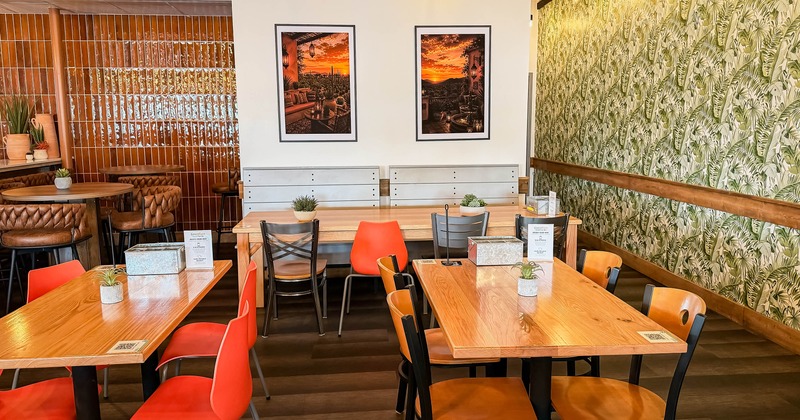 Interior, dining area, wooden top tables for four and eight, leaf motif wallpapers
